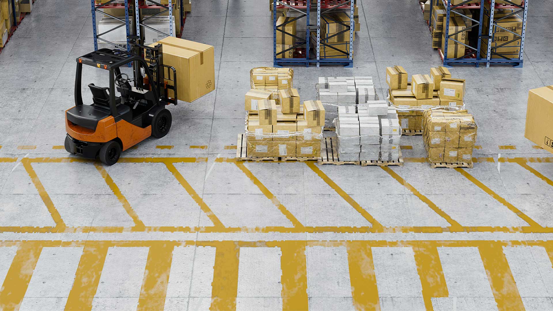 Forklift carrying a large cardboard box in a warehouse aisle with pallets of boxes stacked nearby.